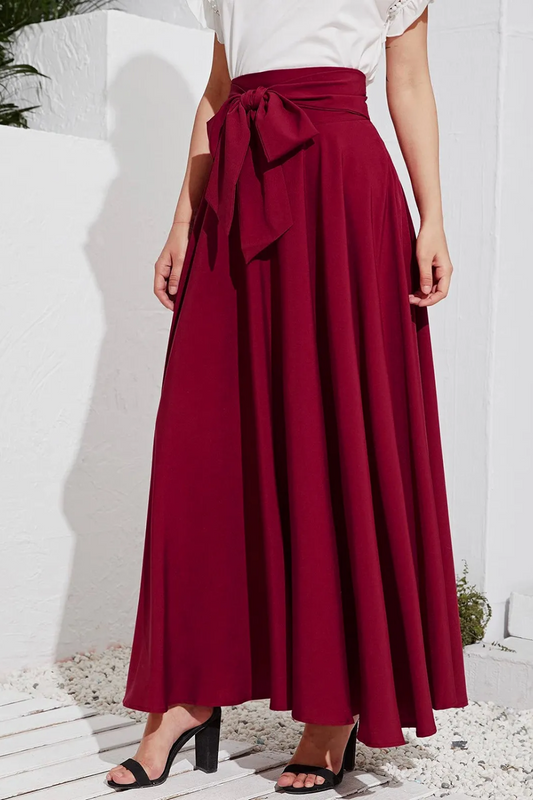 "Upgrade your work wardrobe with this elegant high-waisted pleated skirt. The front bow adds a chic touch, perfect for the office or a stylish lunch date. Made with comfortable, flowy fabric that moves with you.

Available in classic colors to match your favorite tops.

What’s your go-to office look? Pair this with a tucked-in blouse or a fitted sweater for a polished finish. "